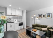 Thumbnail 3 of 11 - a living room with a kitchen and a table